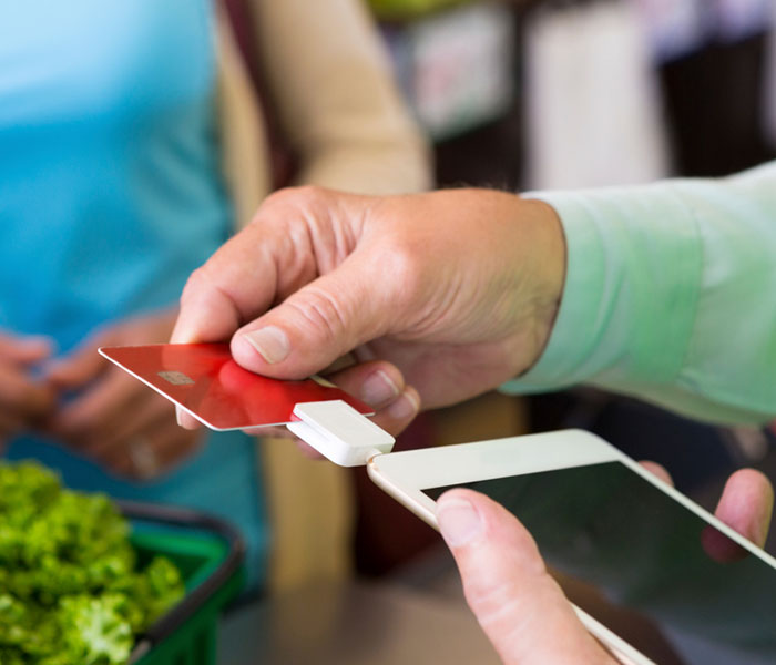 pnb-business-manage Man swiping credit card through machine