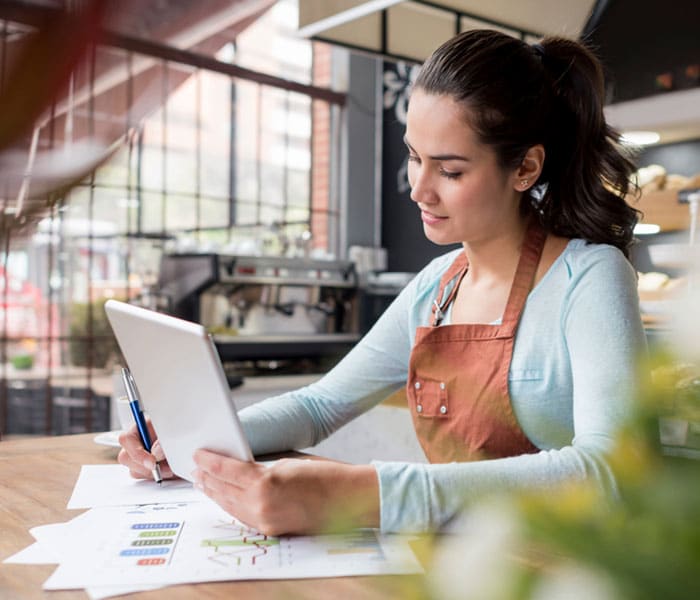 pnb-business-protect Woman looking at her business paperwork