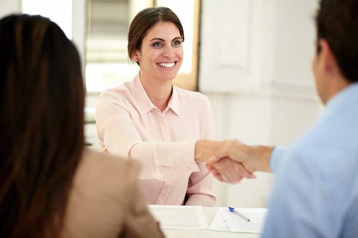 Executive female giving a hand greeting