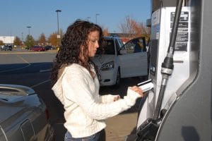 Young woman pays for gasoline at the pump with a credit card. Need photos of teens in action, studying, having fun, living life?