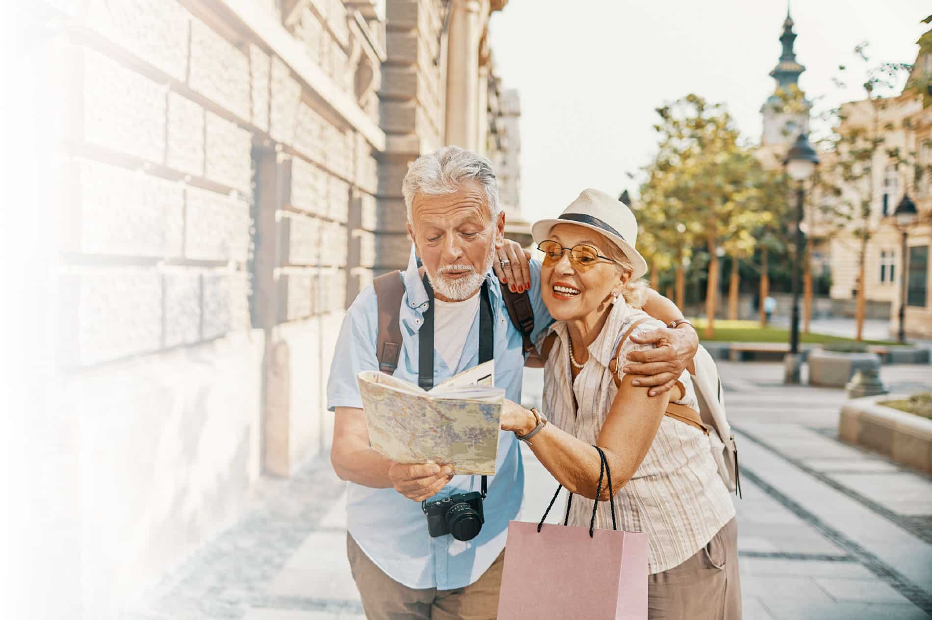 Couple looking at map while exploring city.