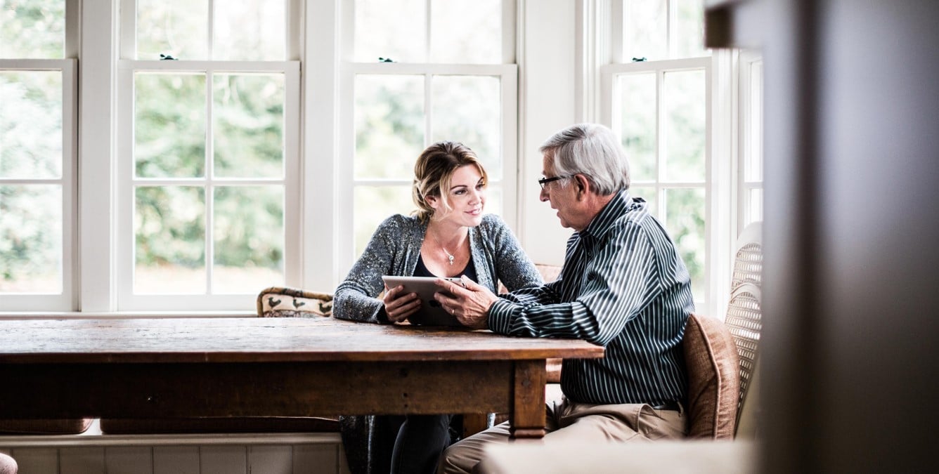 Father and daughter talking together at the table.