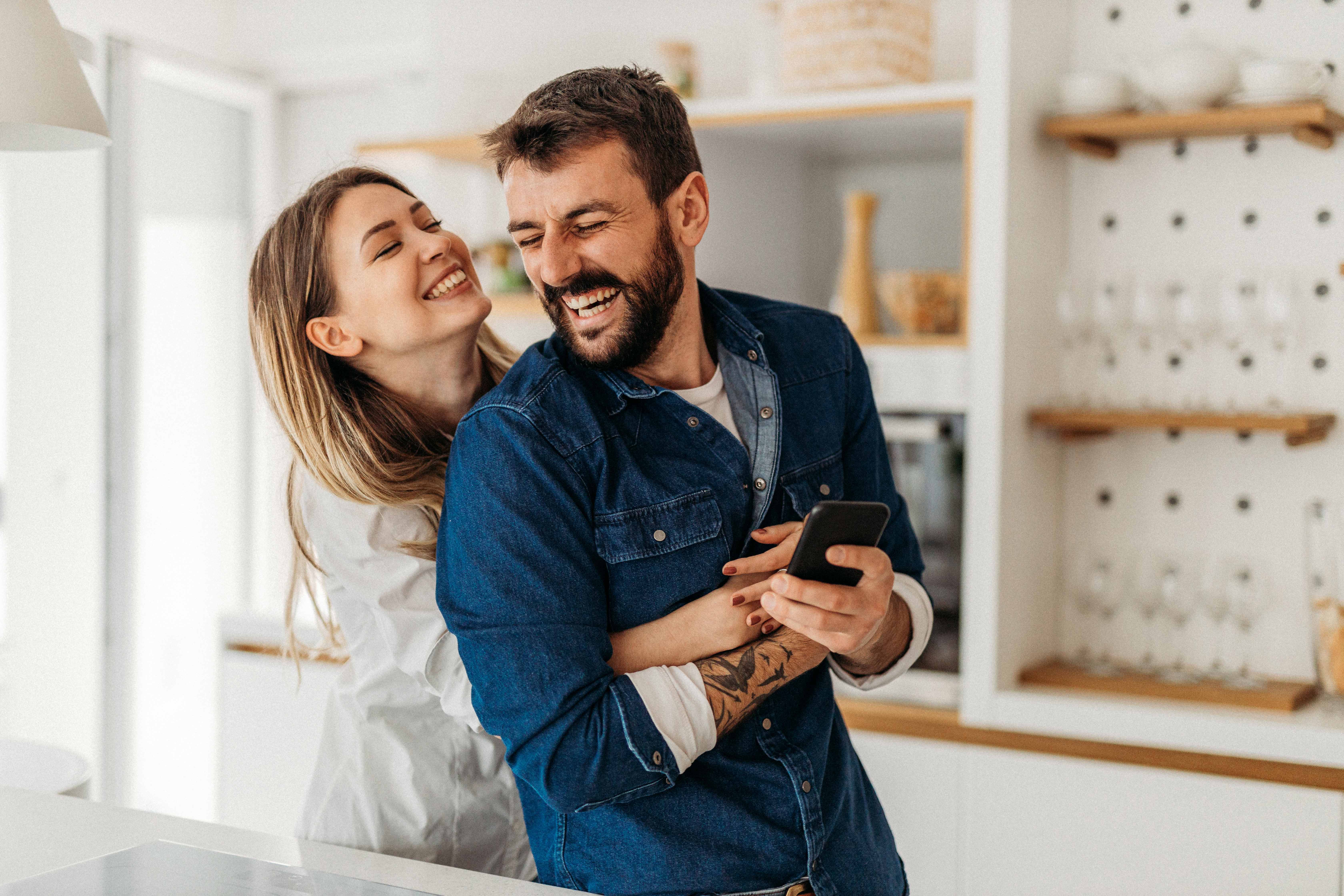 Couple hugging in home