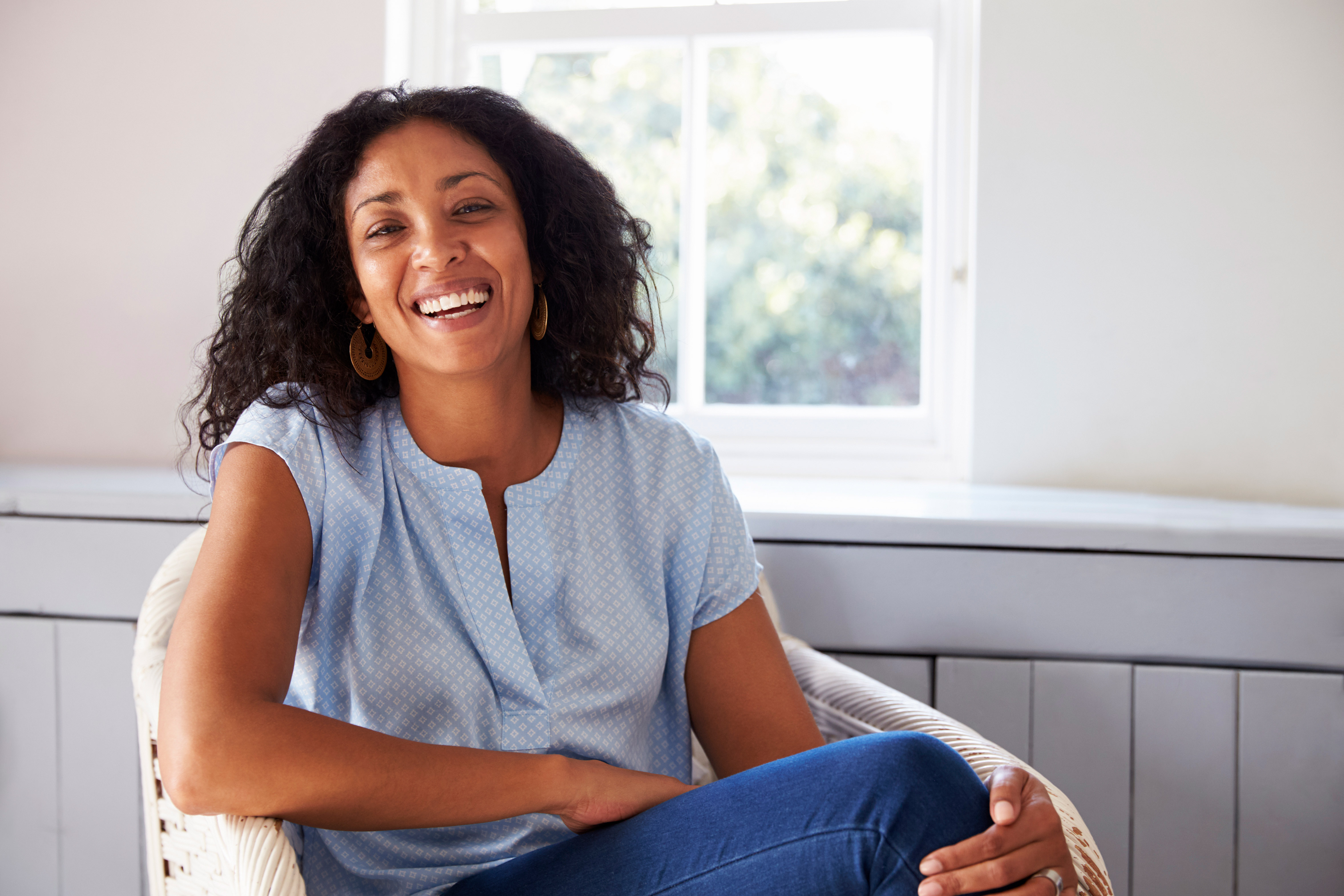 Women sitting by window smiling