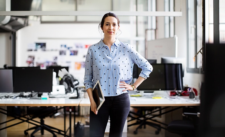 Businesswoman standing with digital tablet